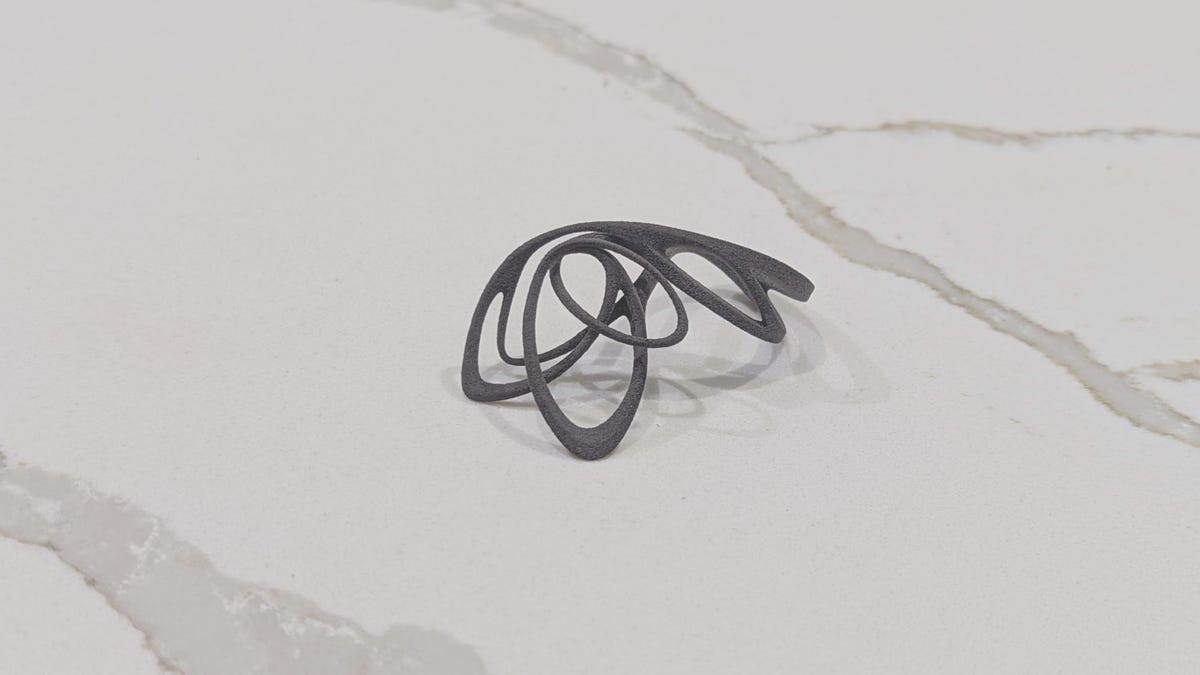 Black 3D printed ring in curvy, flowing lines