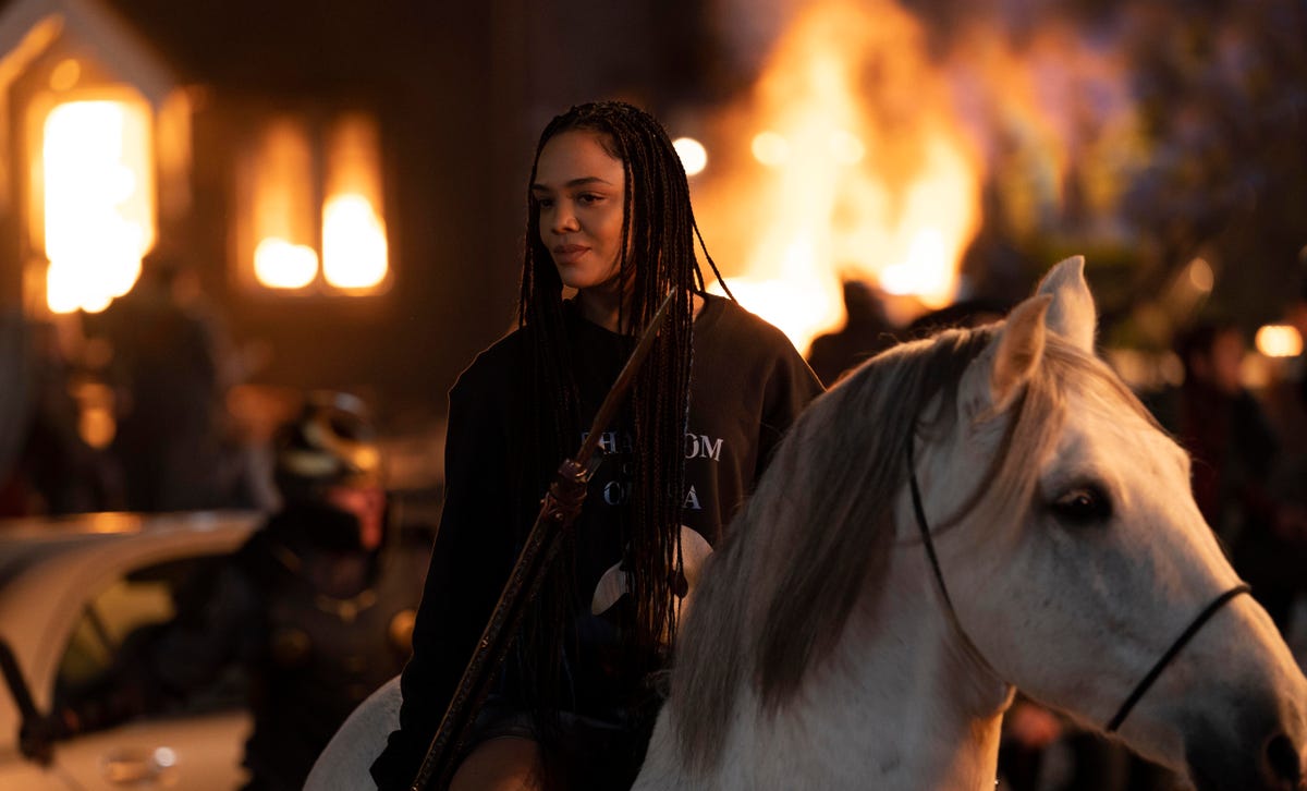 King Valkyrie wears a Phantom of the Opera shirt while sitting on a white horse in Thor: Love and Thunder