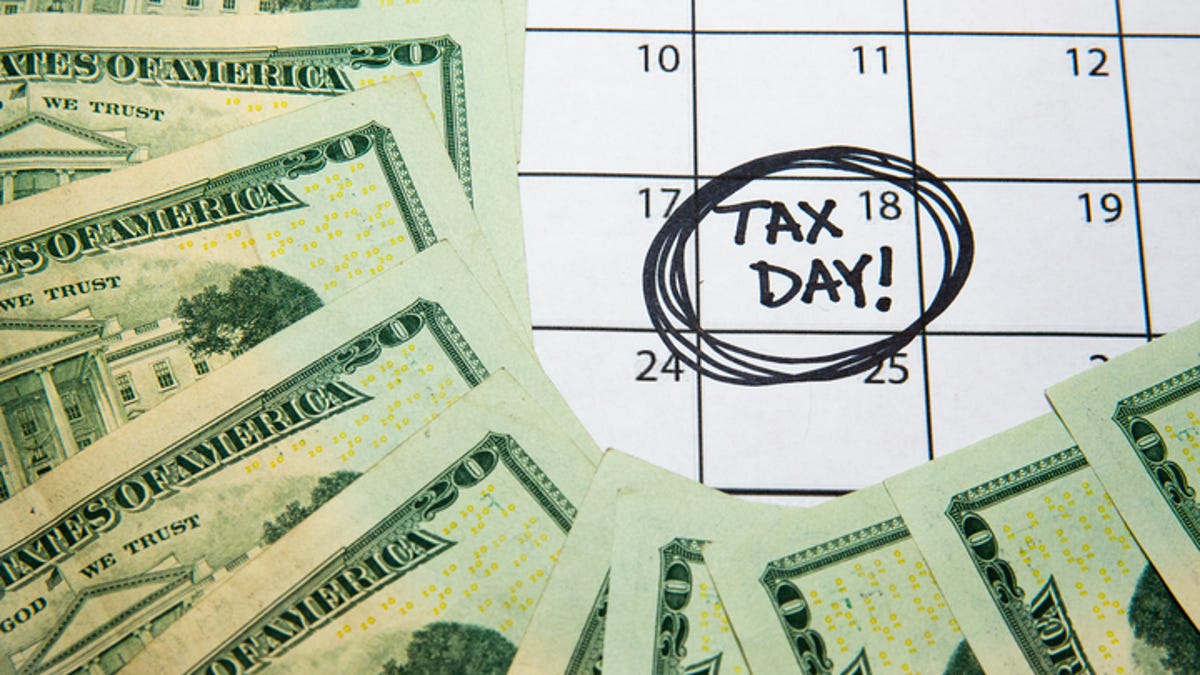 Tax Day April 18 on a calendar with money