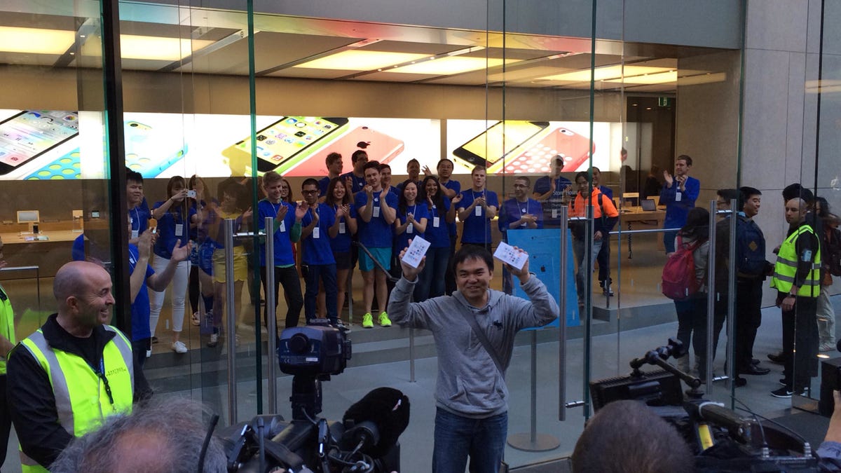 "Jimmy", who arrived at the Sydney flagship Apple Store midday Thursday, walks out with two new iPhones in hand.