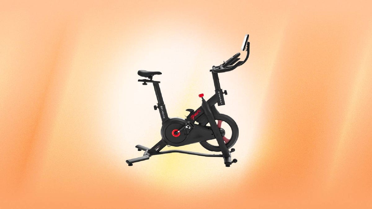 A black and red Echelon exercise bike against an orange background.