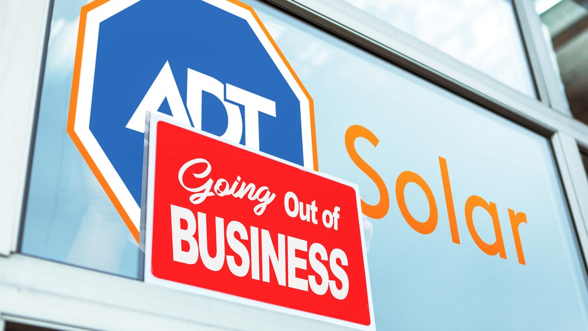 An ADT Solar sign with a going out of business sign on top