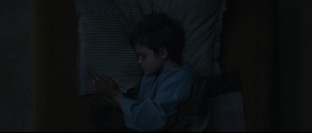 A 10-year-old Luke Skywalker sleeps in his bed in Obi-Wan Kenobi