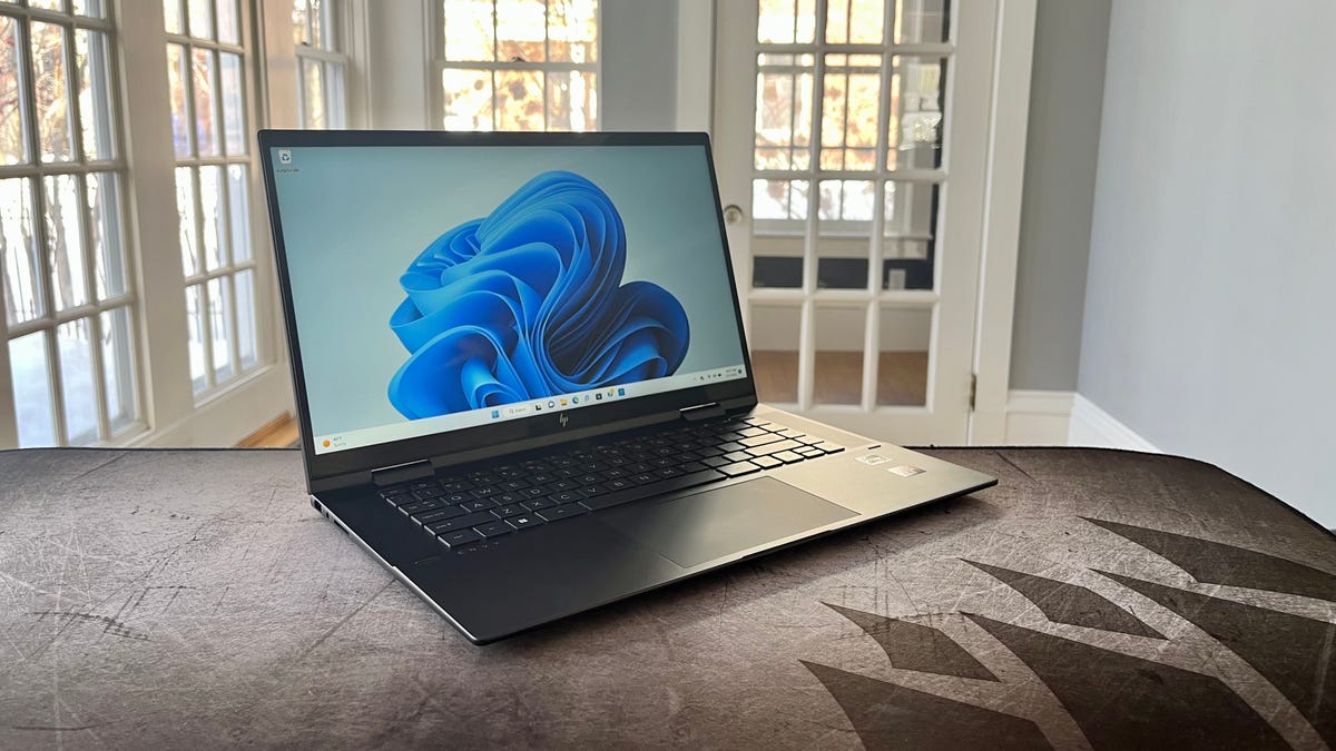 HP Envy x360 on a table in front of a window