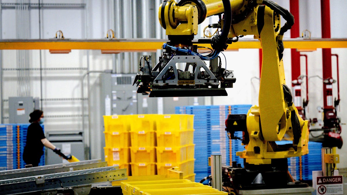 A robotic arm with shipping boxes