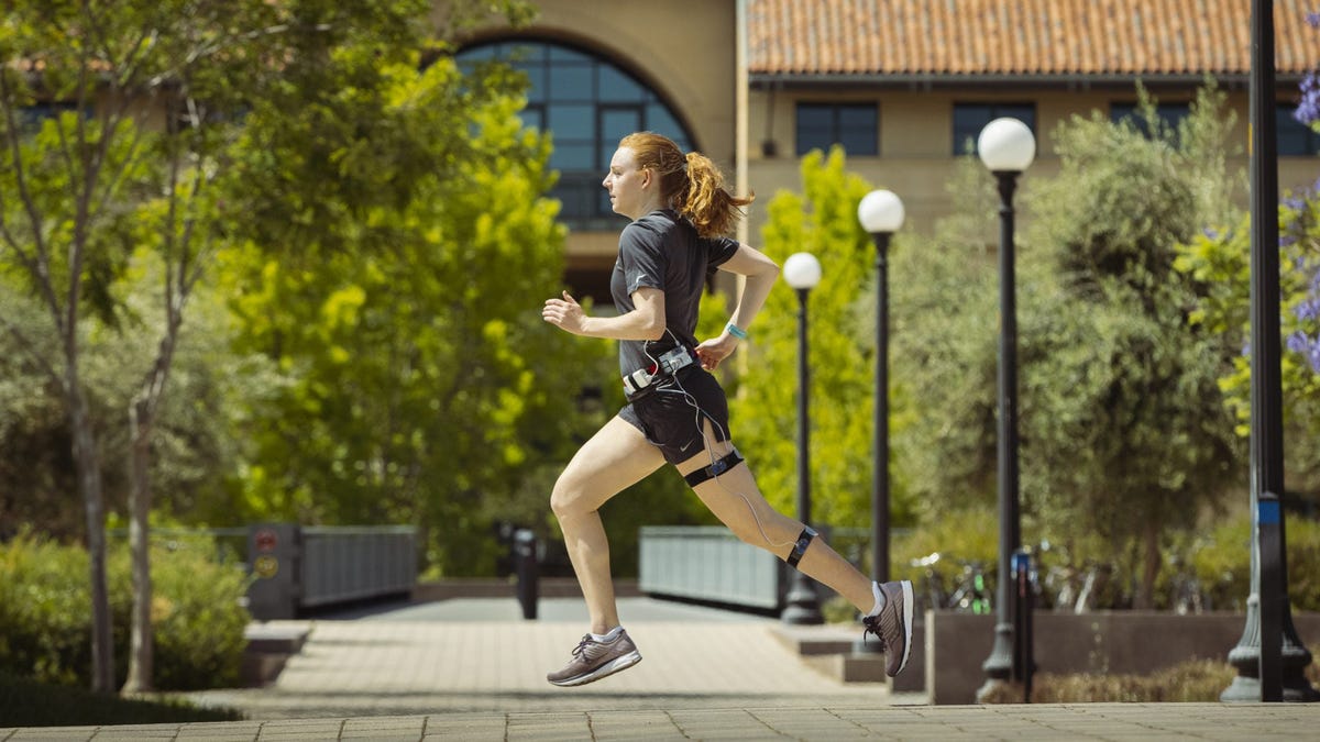 Graduate student Delaney Miller runs wearing Stanford University's leg tracker.