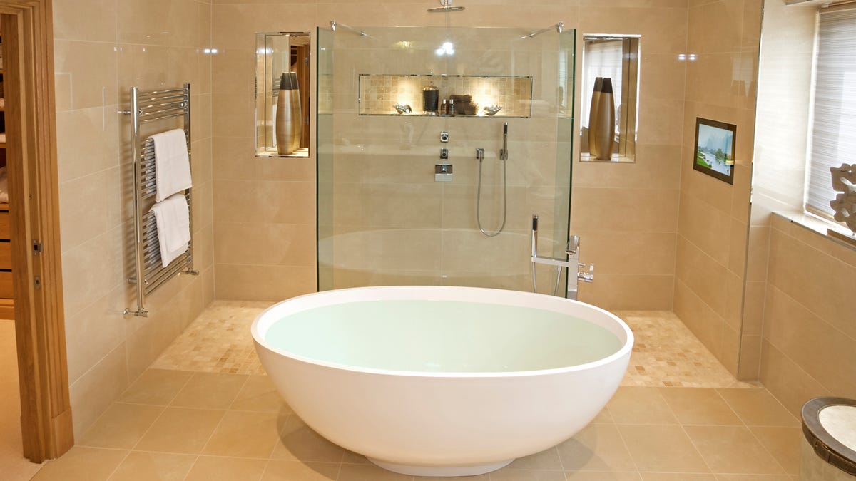 A bathroom with a bowl-like tub in the center