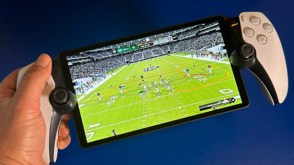 Madden football game playing on screen on PlayStation Portal handheld held in hand