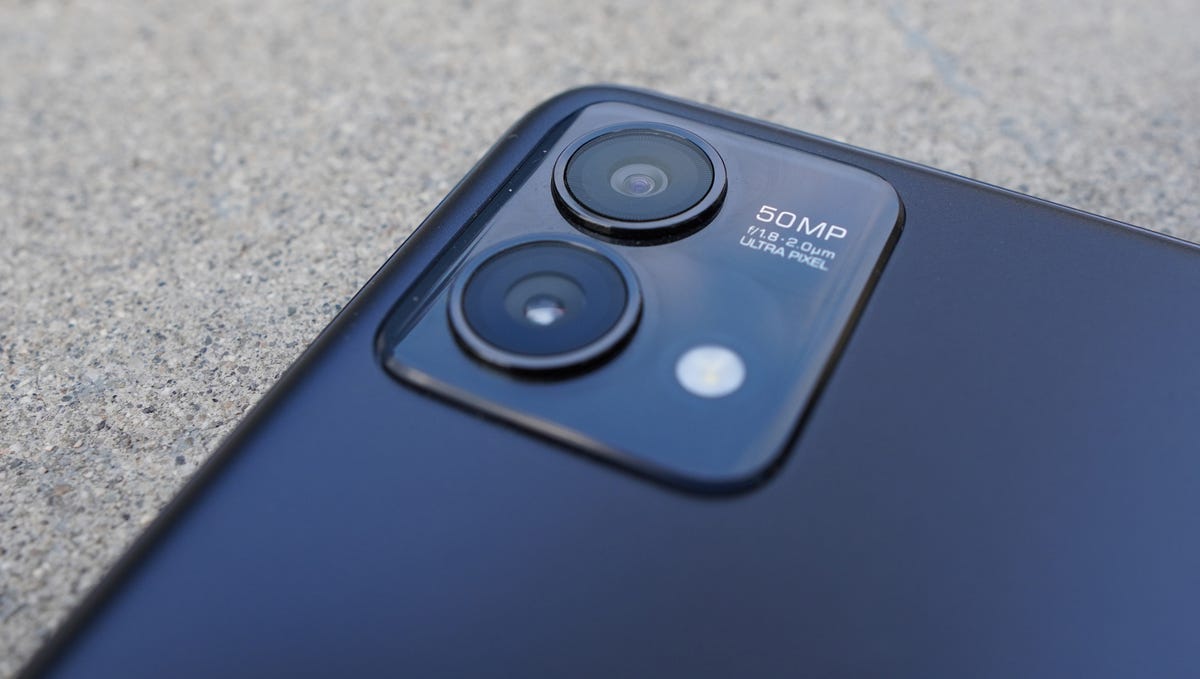 A close-up shot of the dual rear cameras on the back of a gray-blue phone.
