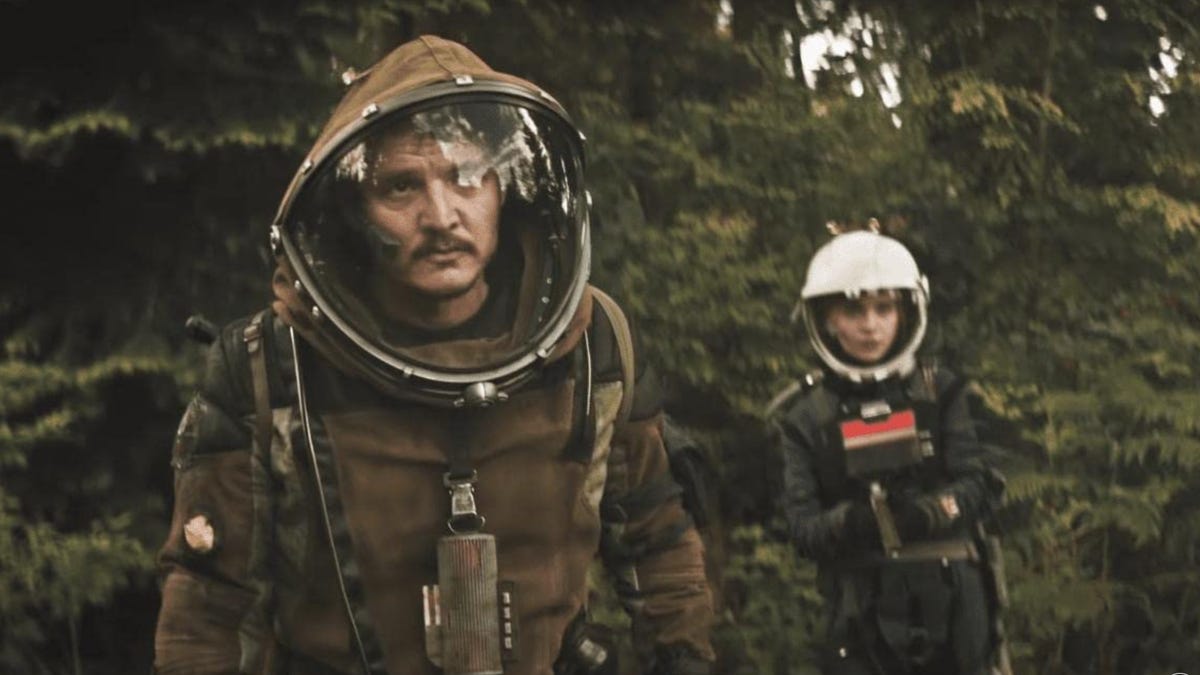 Pedro Pascal and Sophie Thatcher are shown together in a dense, green forest.