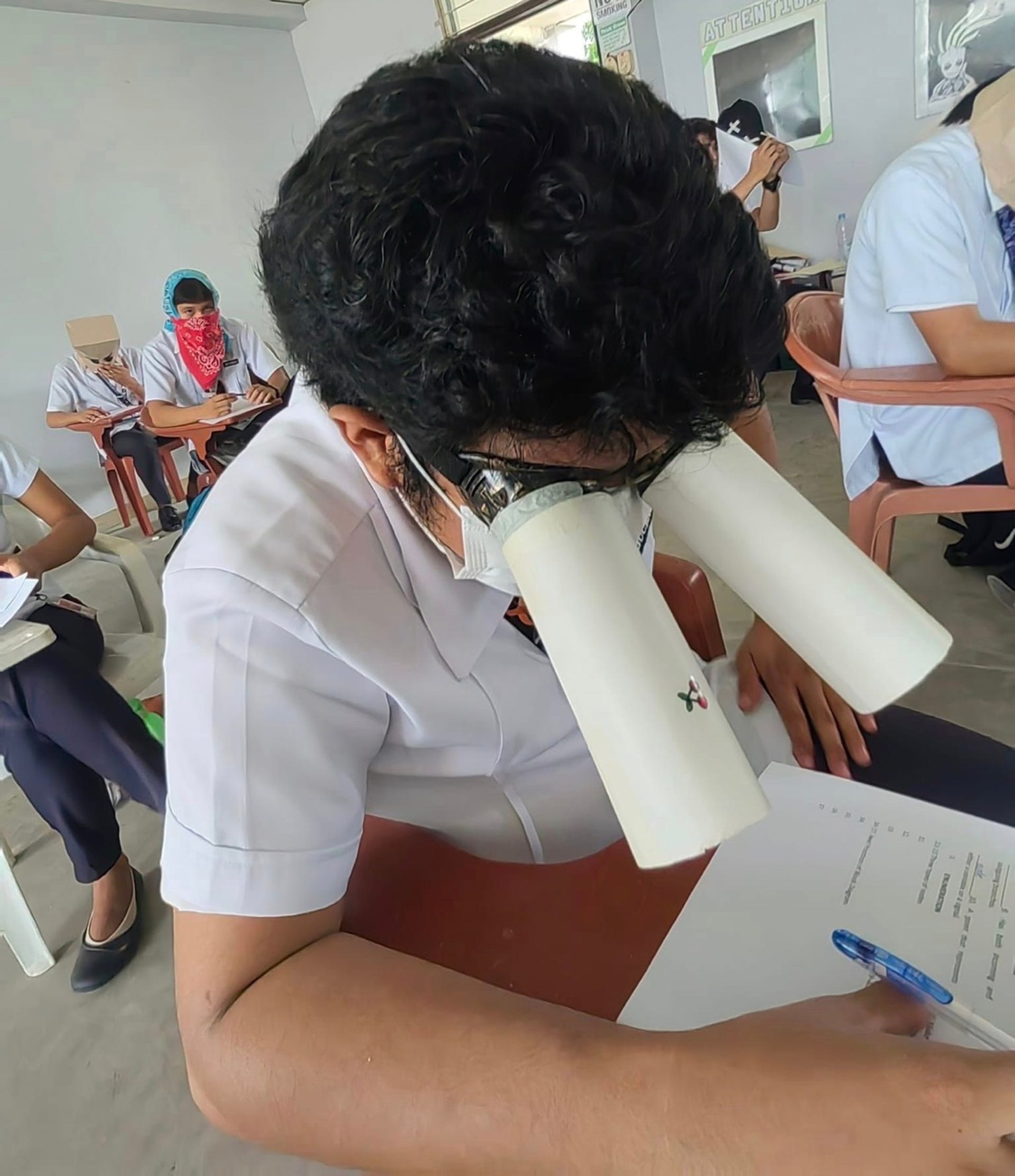 Student attaches tubes to his eyes to block the view of his test