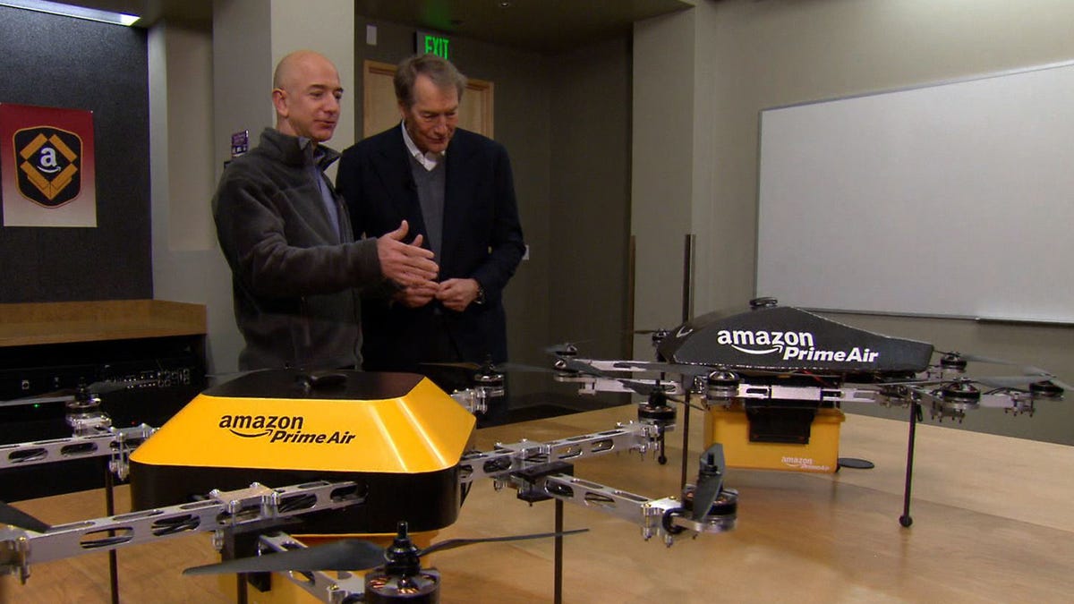 Amazon CEO Jeff Bezos shows Charlie Rose prototypes of the delivery drones.