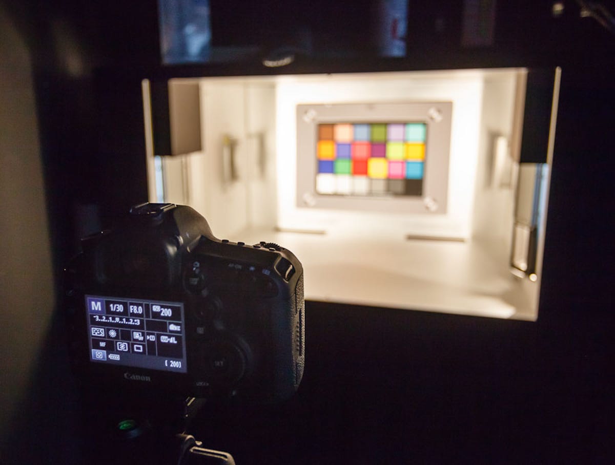 A Canon EOS 5D Mark III stands before a chart that features one of the few splashes of color in this DxO Labs testing facility.