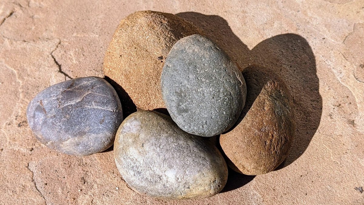 A small pile of rounded, vaguely potato-shaped stones in shades of gray and brown.