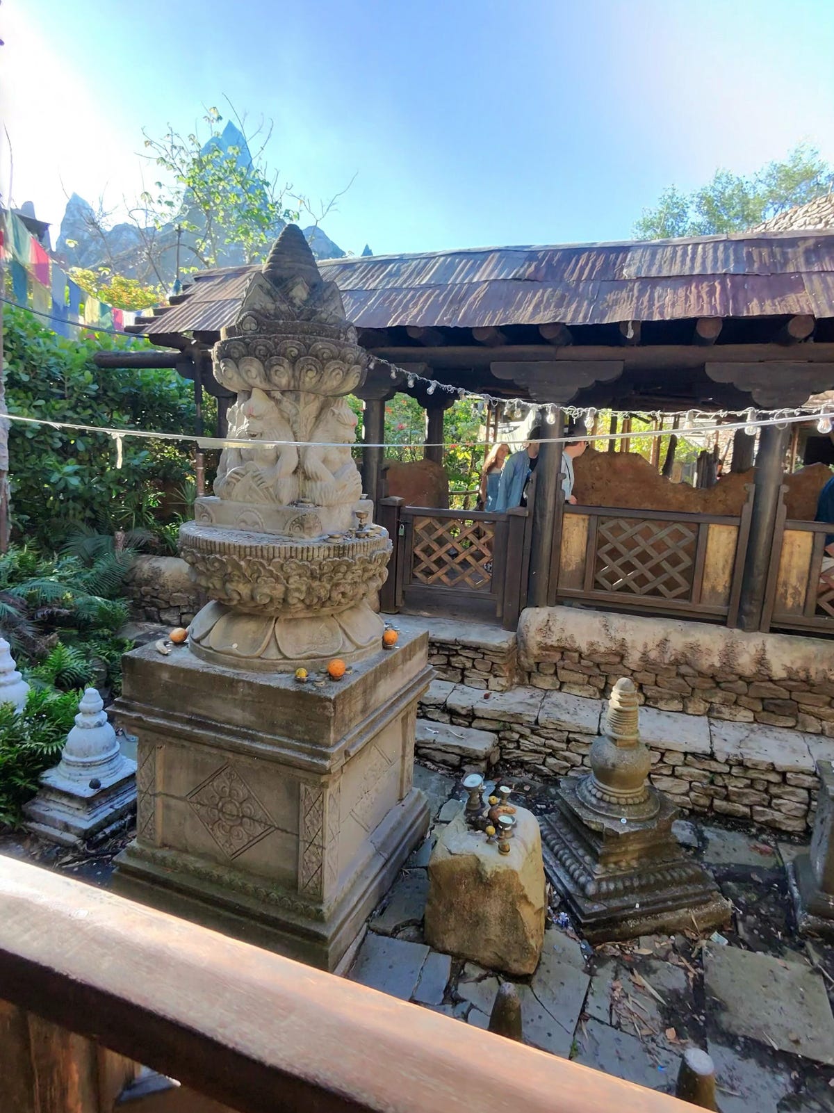 A photo of an ancient courtyard, part of a theme park ride line at Disney