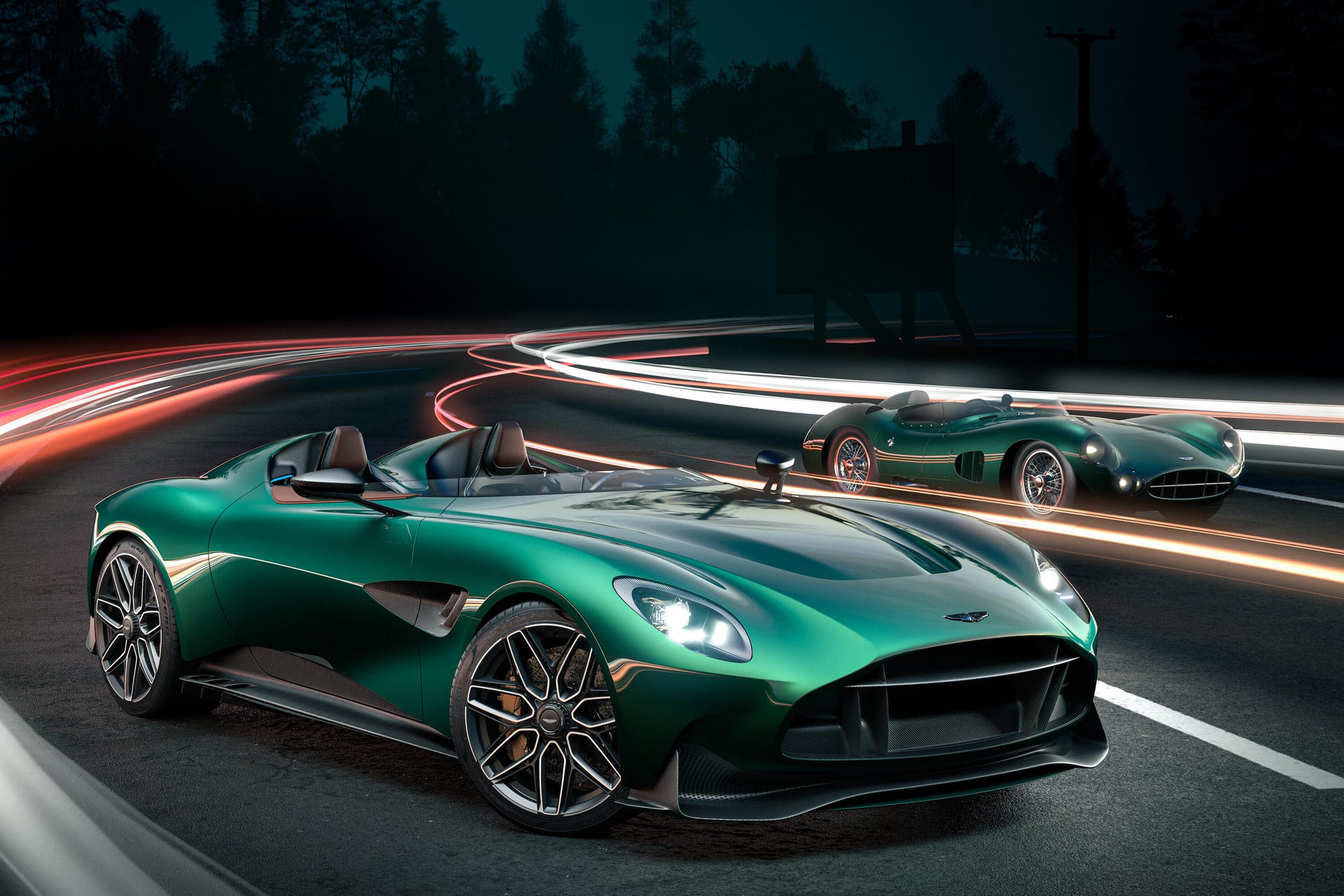 Front 3/4 of a green Aston Martin DBR22 speedster in front of a vintage DBR1 race car