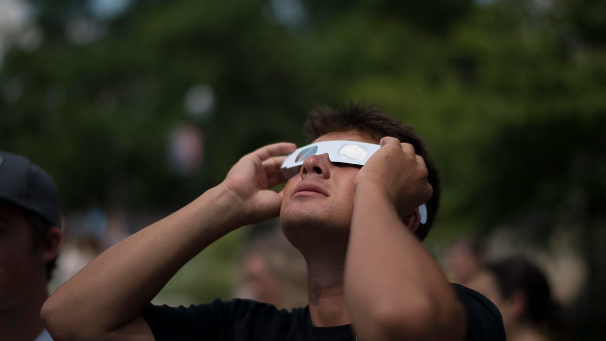 A person looking up at a solar eclipse