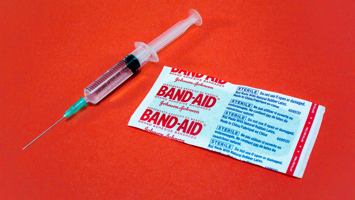 A hypodermic and a Band-Aid in its wrapper