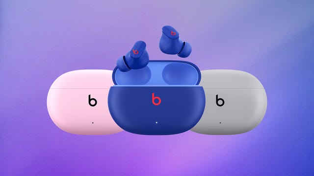Three different colored pairs of Beats Studio Buds earbuds.