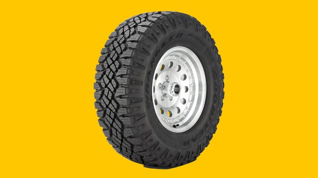 Goodyear Wrangler DuraTrac tire pictured on a yellow background