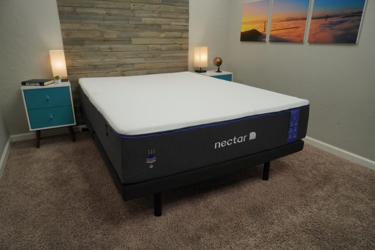 The Nectar Premier mattress with a blue nightstand subsequent to it. 