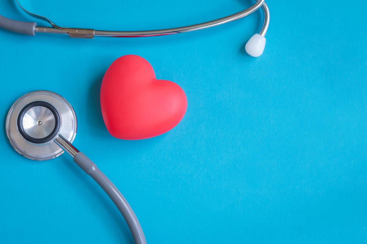 A heart and stethoscope against a bright blue background