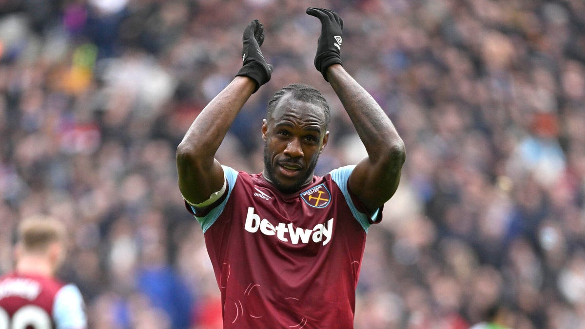Michail Antonio of West Ham United celebrating, applauding with both hands above his head.