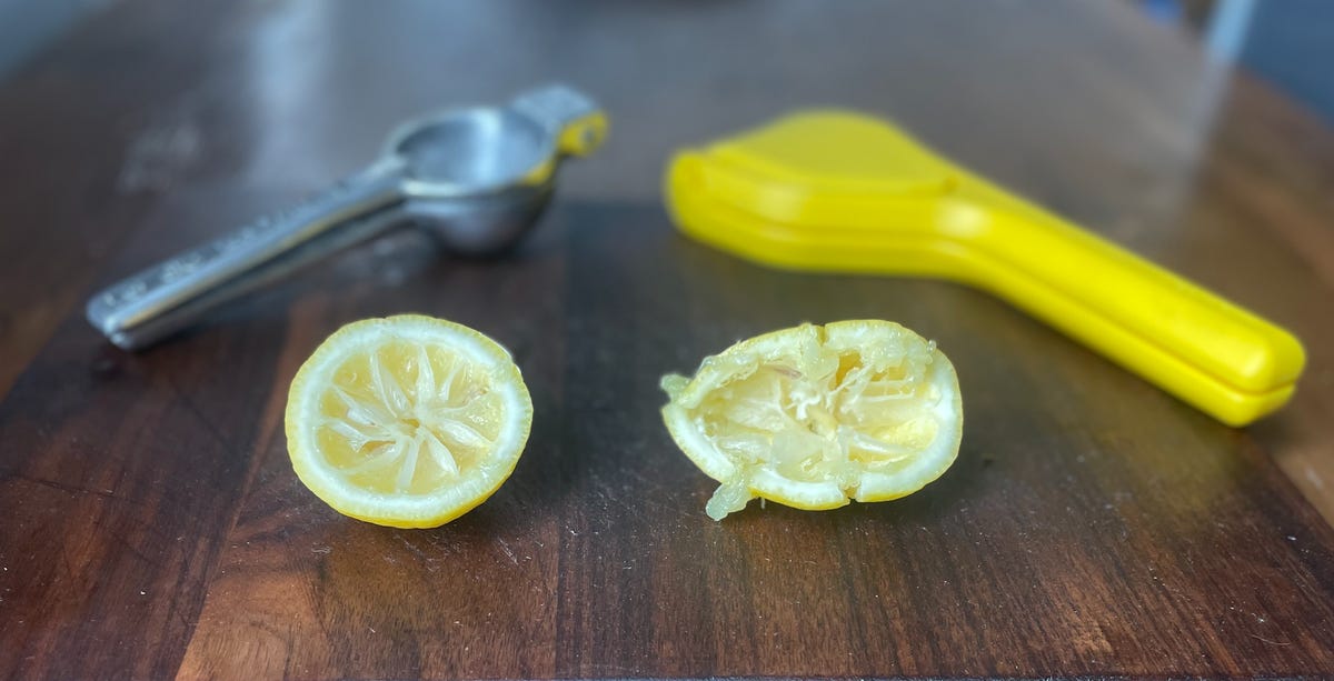 fluicer and traditional juicer with squeezed lemons