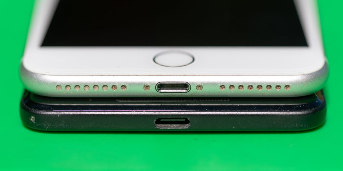 An iPhone 7 Plus with Lightning port sits atop a Google Pixel 2 XL with USB-C port.