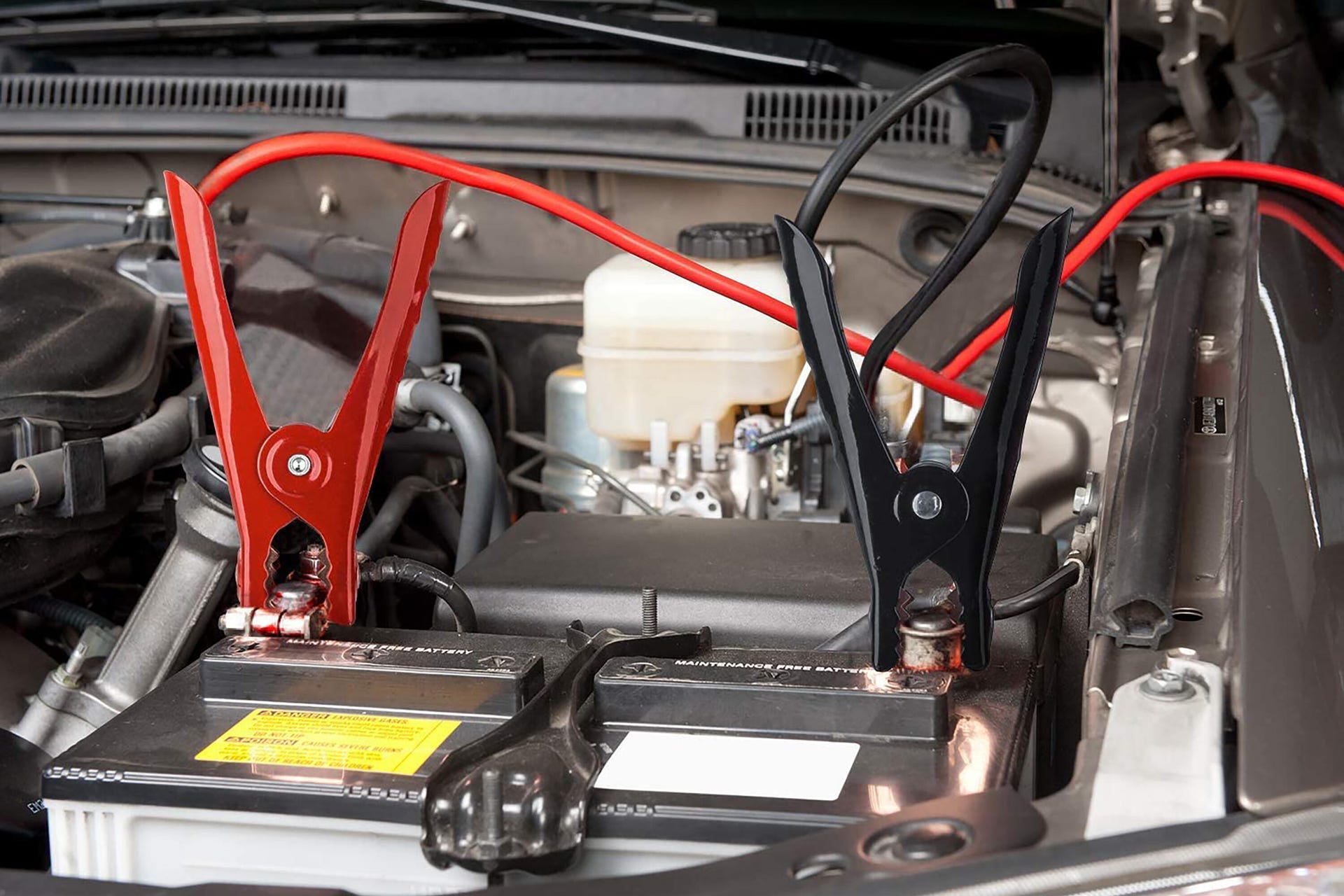 Jumper cables clamped on a car battery