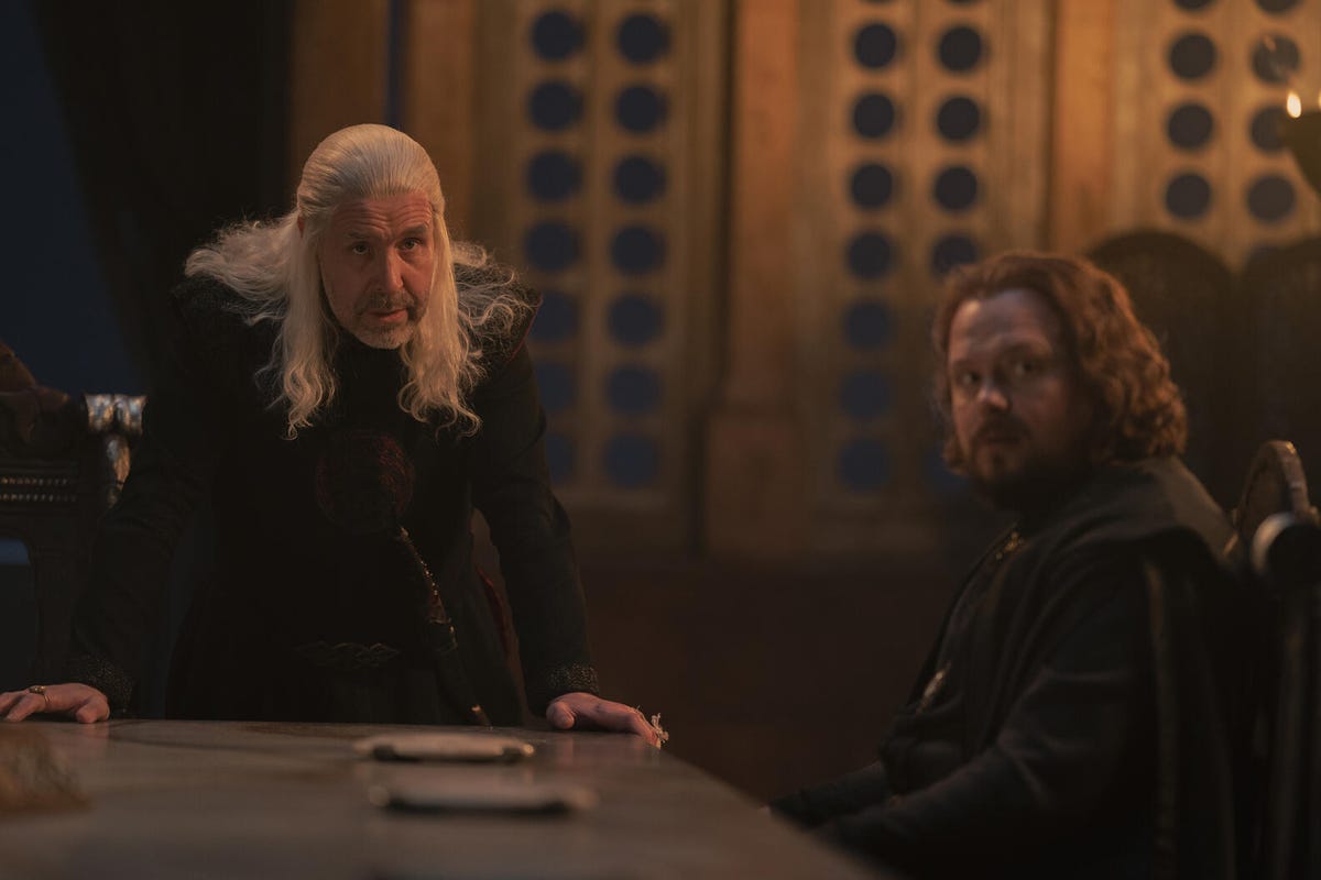 King Viserys and Lord Lyonel in discussion at a table