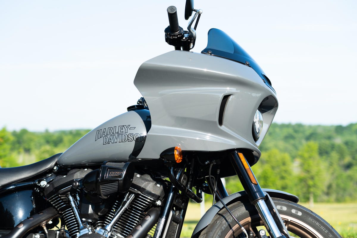 The Harley-Davidson Low Rider ST in grey, long and low with saddlebags on a bright sunny day.