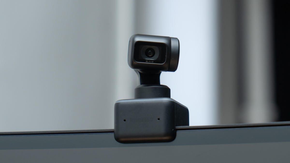 Insta360 Link webcam perched on top of a monitor