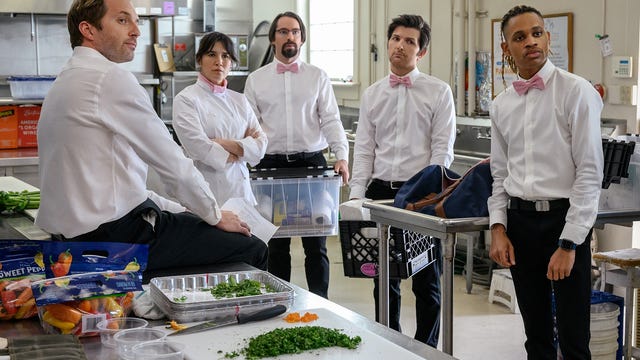 Ryan Hansen, Zoe Chao, Martin Starr, Adam Scott, Tyrel Jackson Williams dressed as caterers in a kitchen.