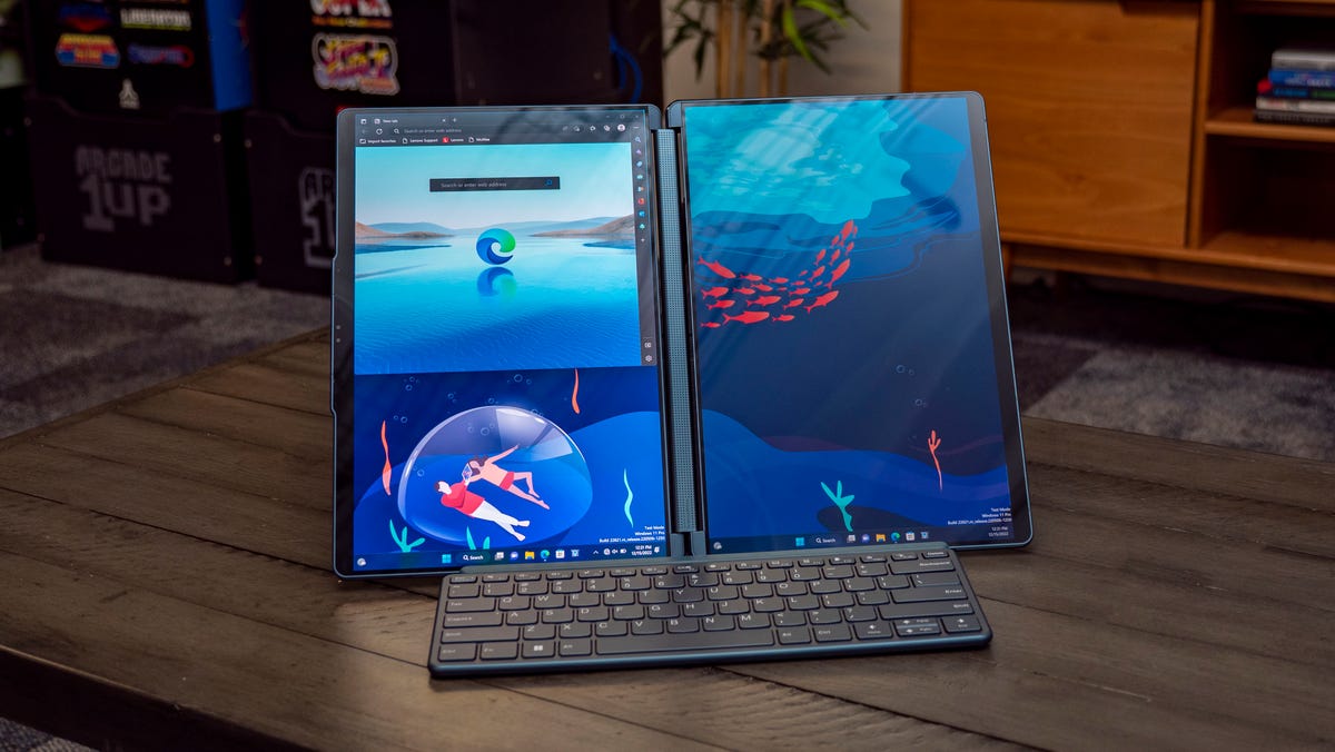 Lenovo Yoga Book 9i dual-screen laptop in landscape position with included Bluetooth keyboard on the front.