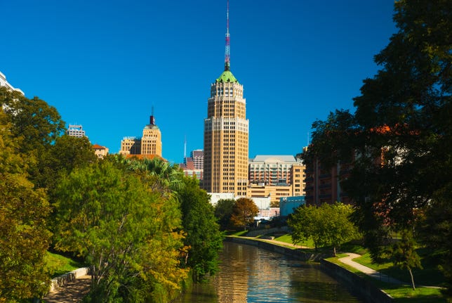 Downtown San Antonio, including the riverwalk and the Tower Life Building in the distance.