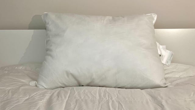 Parachute Down Alternative Pillow on a white bed.