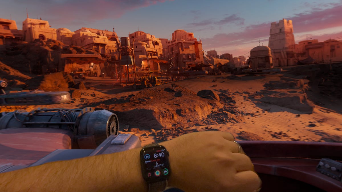 A hand with a watch with a Star Wars landscape behind it