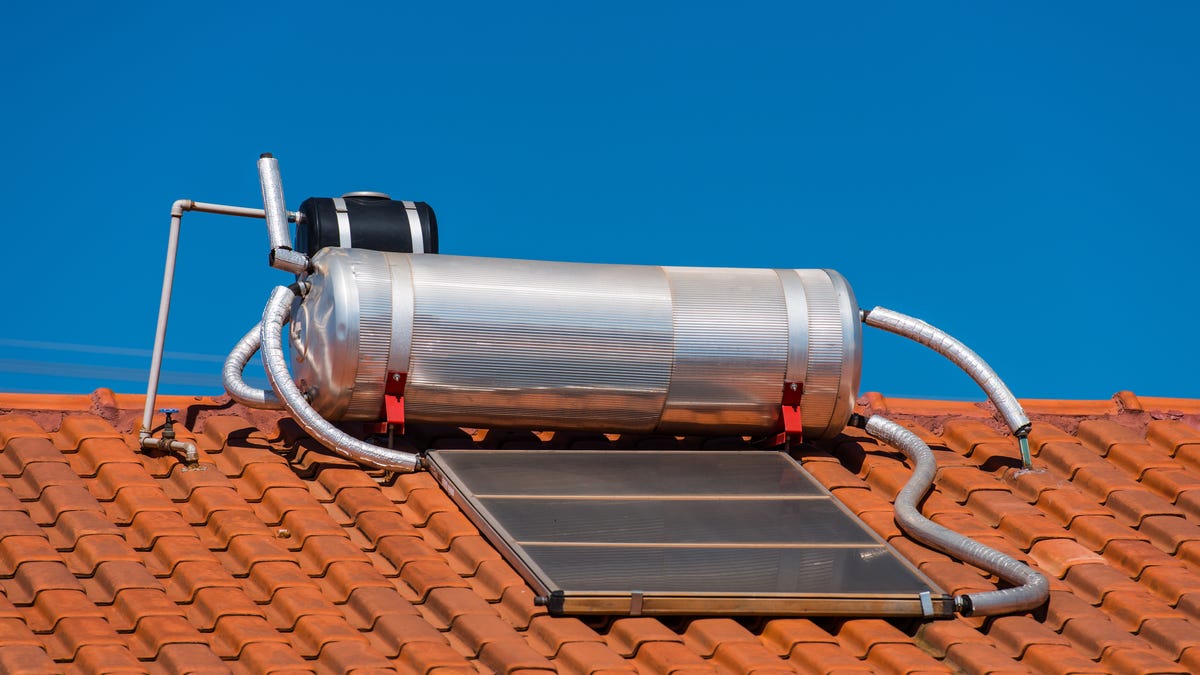 A solar water heater on a tile roof.