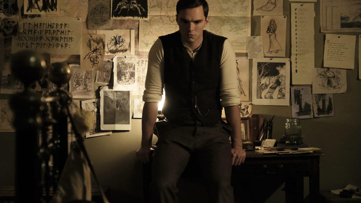 Nicholas Hoult broods as JRR Tolkien in a semi-darkened room plastered with notes and drawings.