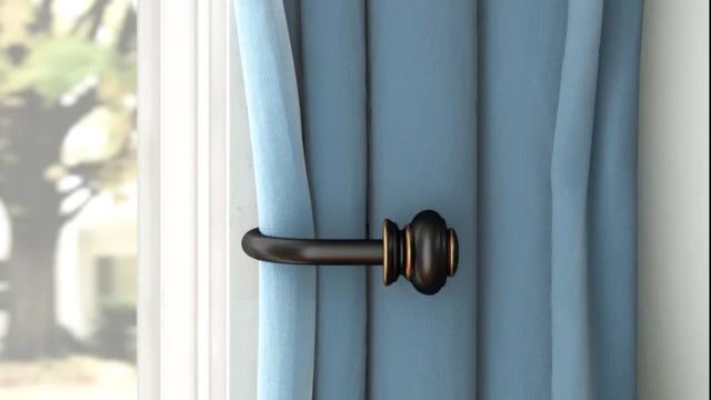 Black curtain holdbacks hooked to a blue curtain