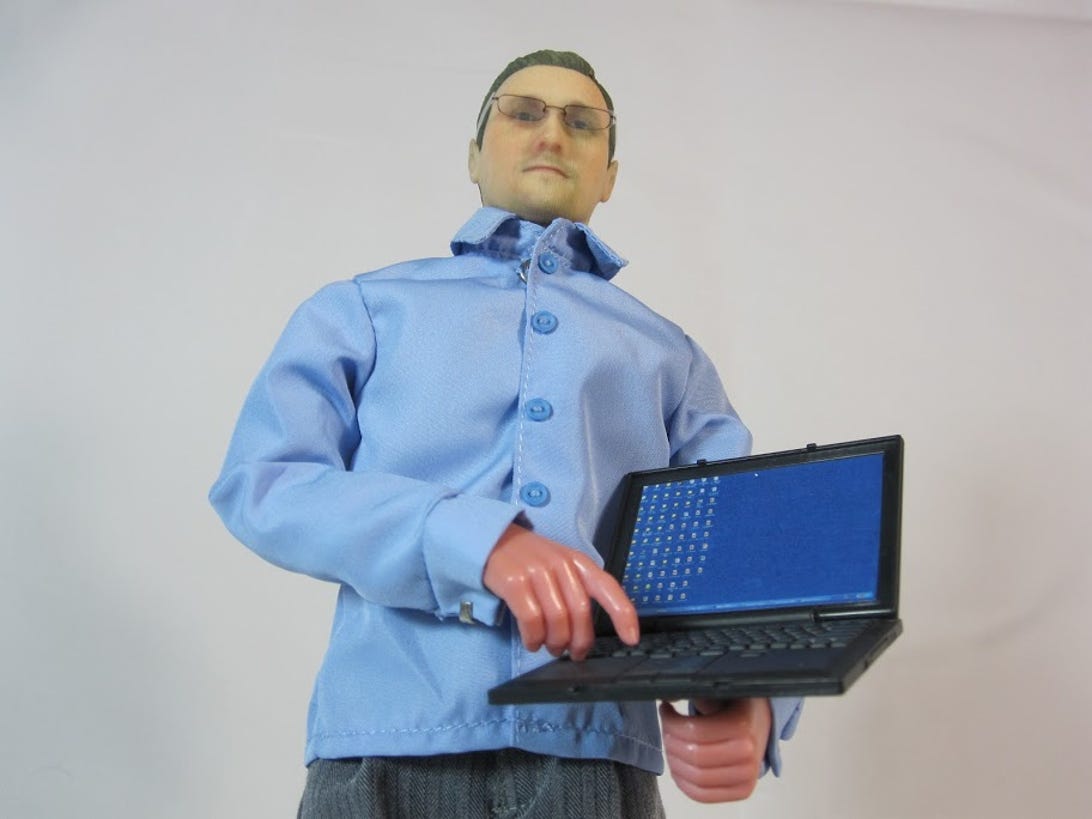 Edward Snowden action figure with laptop