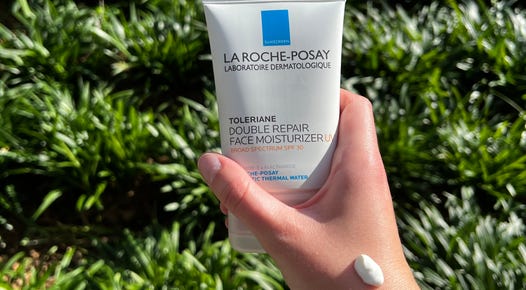 Hand holding La Roche-Posay Sunscreen