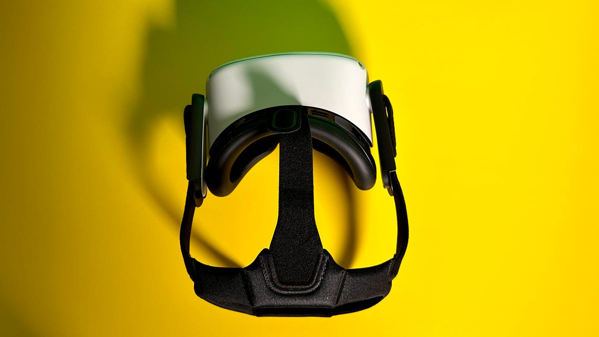 Quest 2 VR headset with a black strap on, sitting on a yellow surface