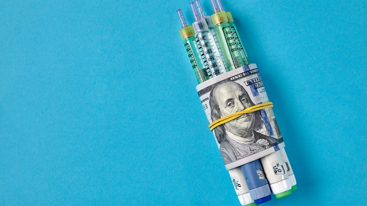 Insulin syringes wrapped in a hundred-dollar bill