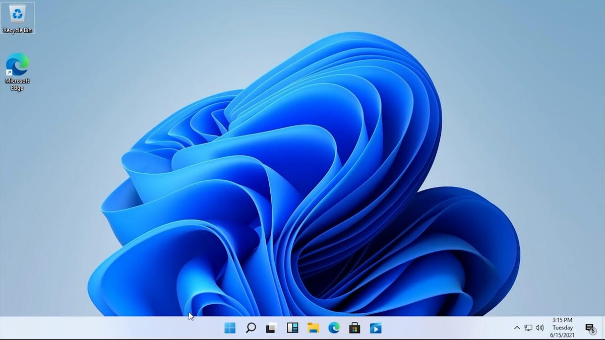 a Windows 11 desktop with a blue flowing wallpaper