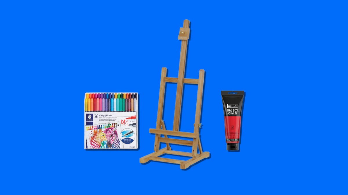 Markers, easel and paint on a blue background