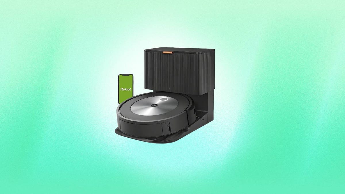 A Roomba robot vacuum and base station against a green background.