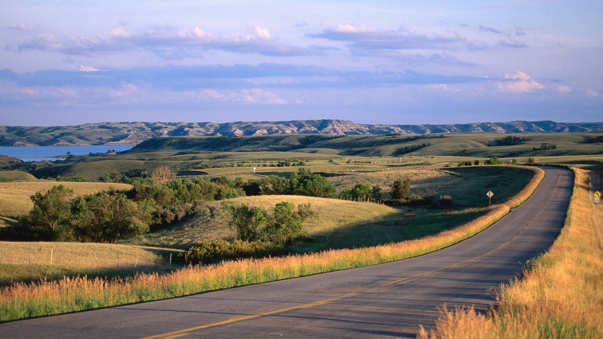 Lake Sakakawea in North Dakota, with grasses in the foreground and hills in the background.