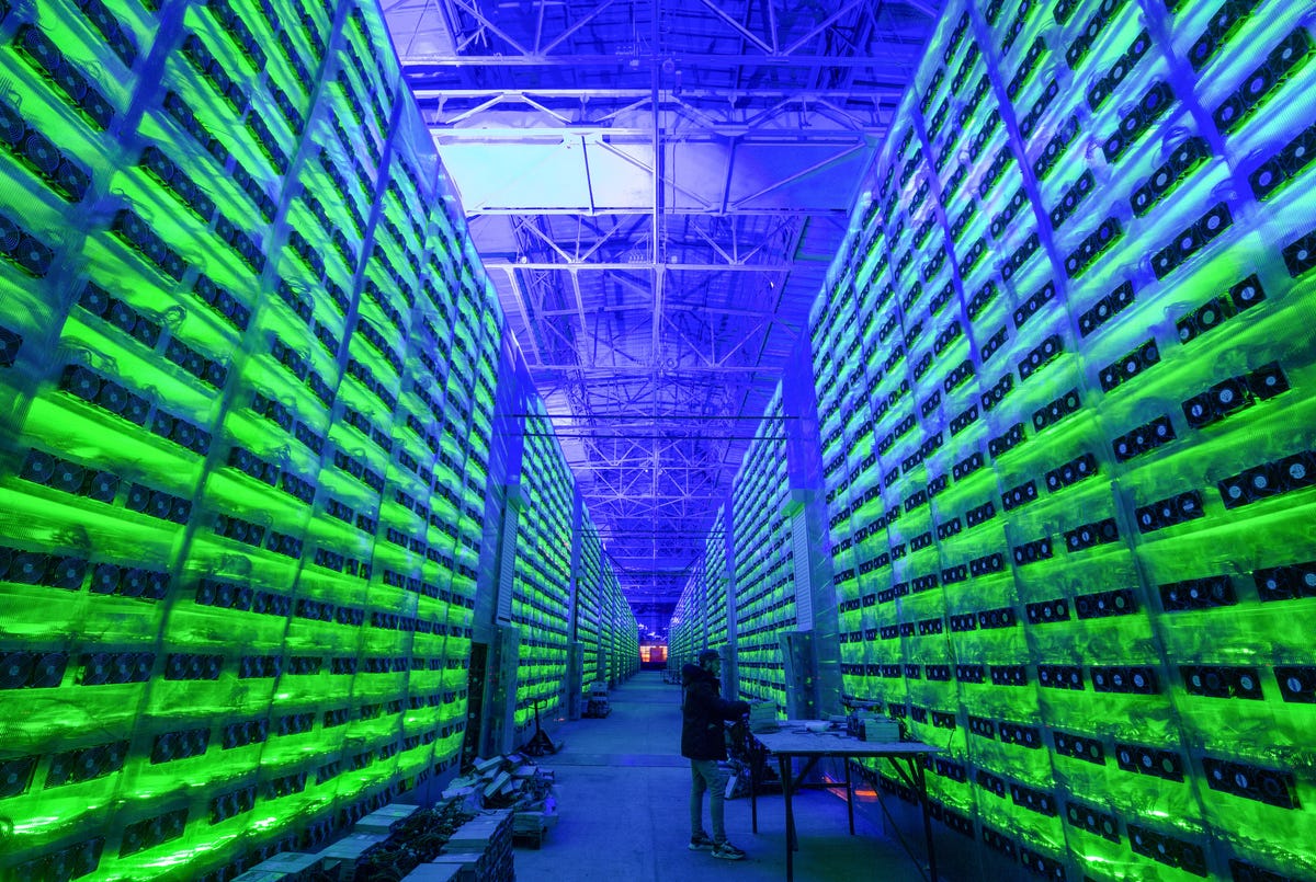 A crypto mining farm, in shades of green and blue, in Nadvoitsy, Russia.
